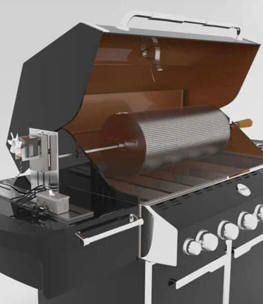 An RK perforated stainless drum and motor mounted inside an open gas grill — the grill becomes the roaster