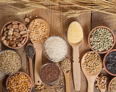 various grains on a wooden table.