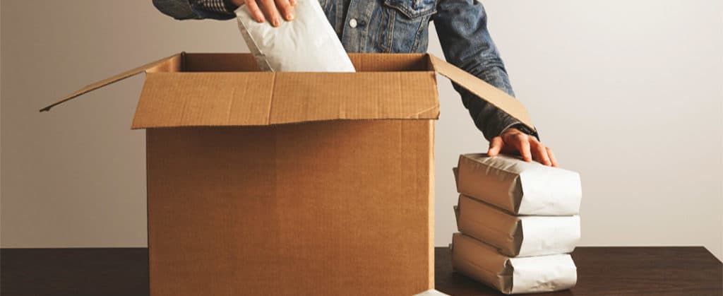 coffee bags being taken out of carton box