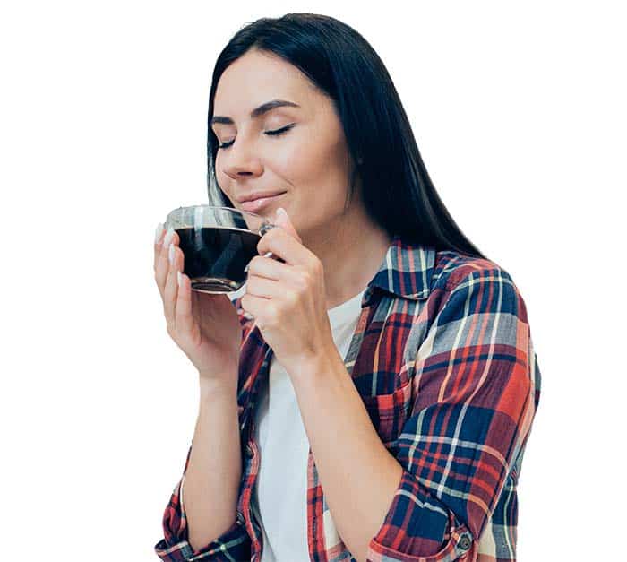 young woman smelling black coffee