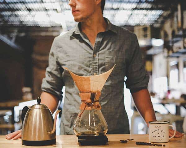 man standing with the chemex on the table