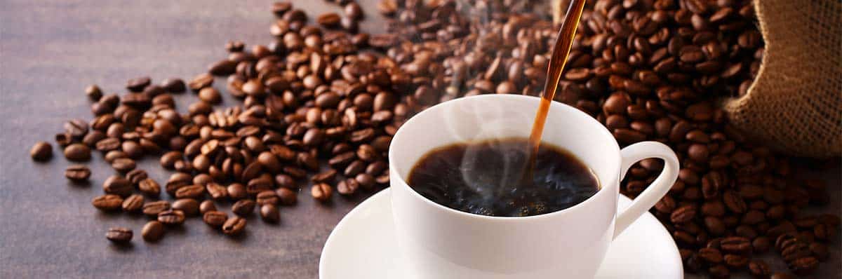 coffee cup and coffee beans on a table