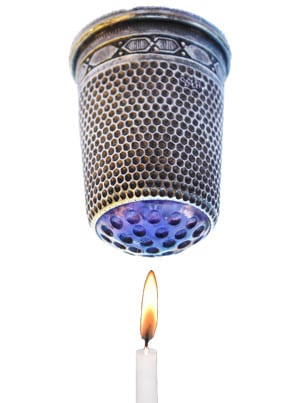 thimble and a candle underneath