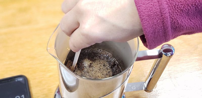 breaking the floating grinds is what is called "breaking the crust" in the french press